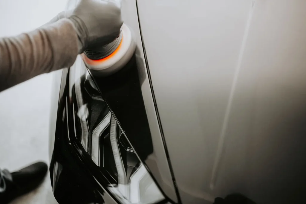 Buffing machine bringing up gloss on black paint