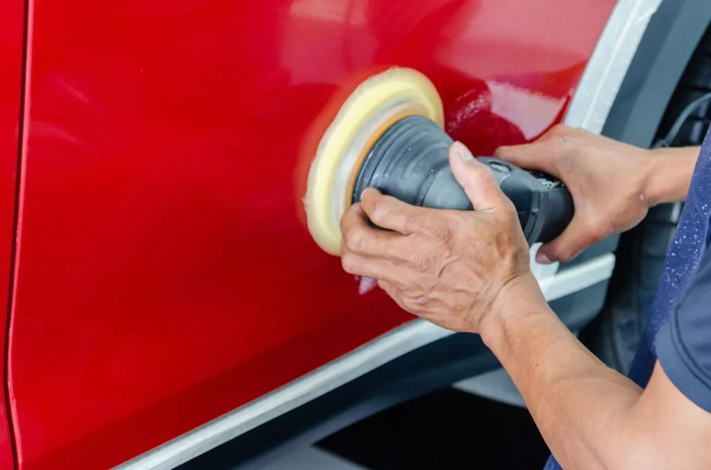 Buffing the paintwork on a red car