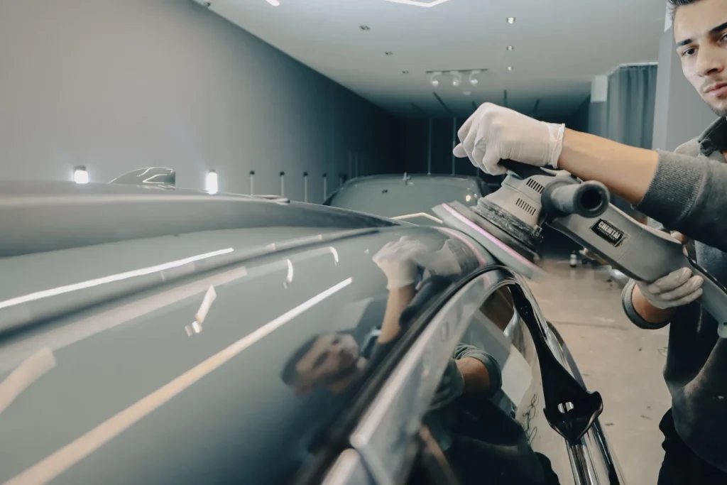 Machine polishing a car roof in a body shop