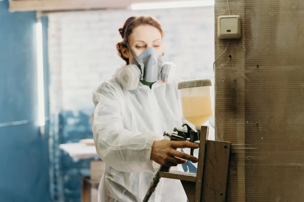 Spray gun laying down colour in a workshop